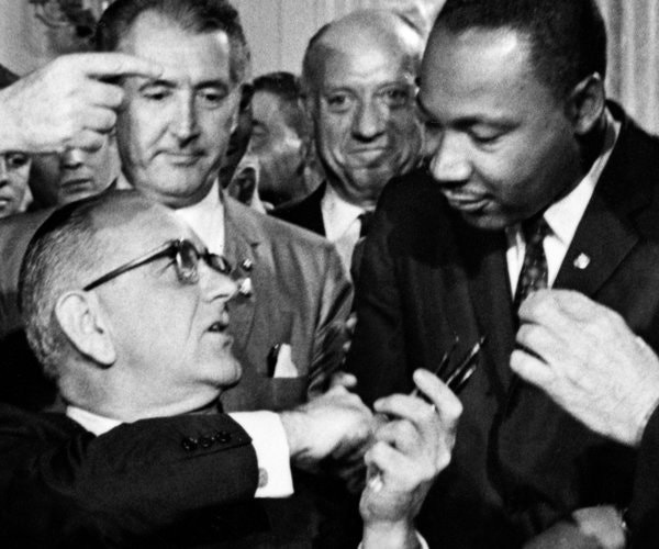 Presidents Johnson hands Martin Luther King a pen after signing the Civil Rights Act 1964. Read about in Branch’s Pillar of Fire. 