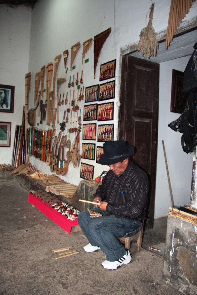 Close-up of the instrument maker. Producing a small pan flute.