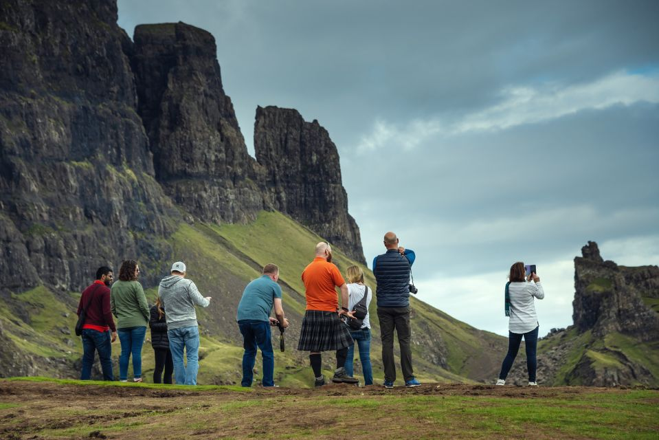Impressions of the Isle of Skye region, Scotland. Landscape with tour group & guide in foreground.