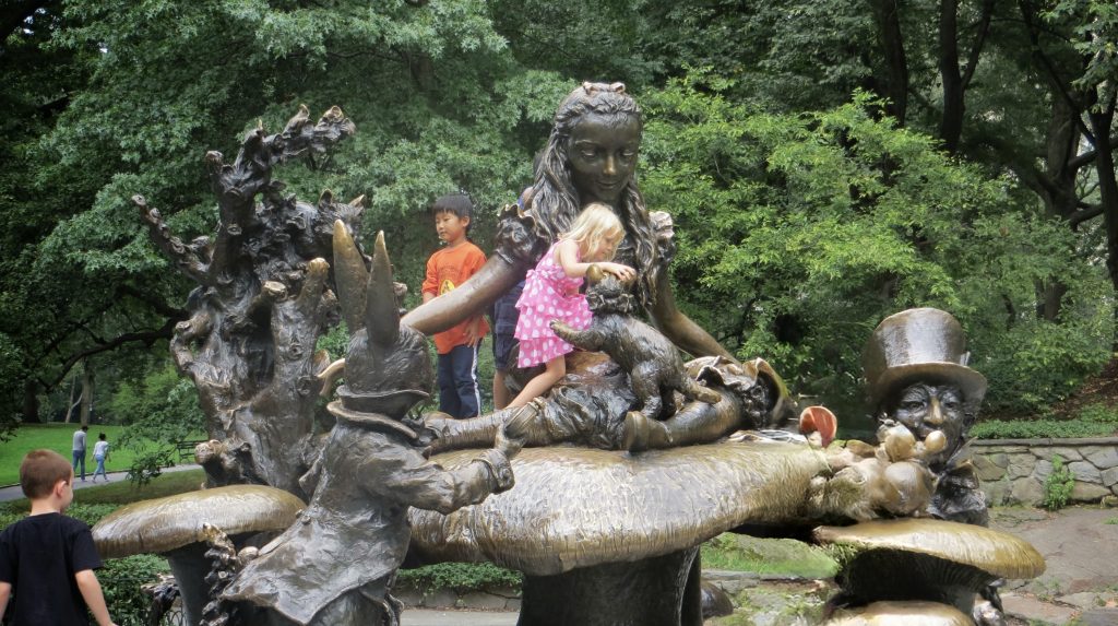 Large bronze statue of Alice, the Mad Hatter & the White Rabbit from Lewis Carroll's classic book.