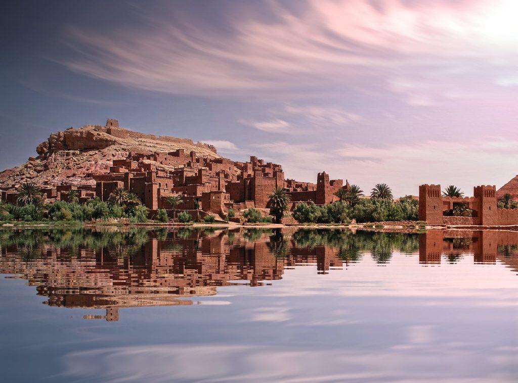 brown concrete building near body of water visit Morocco