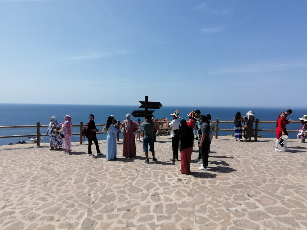 People standing at the border of the Mediterranean Sea (right) and the Atlantic Ocean (left), Tangier, Morocco. 