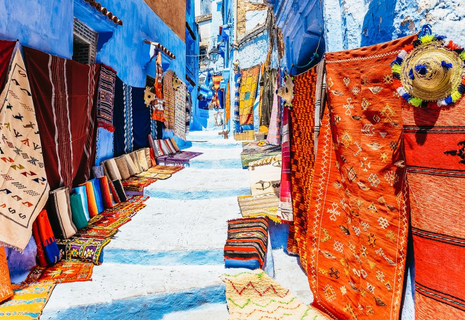 Alleyway - photographed during a visit to Chefchaouen - full of beautiful & colorful rugs, and other handicrafts. 