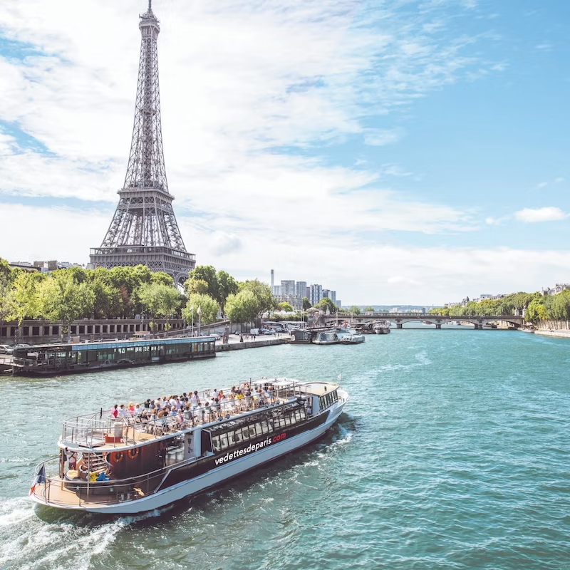 Cruise boat on the Seine, Paris. In the background the Eiffel Tower.