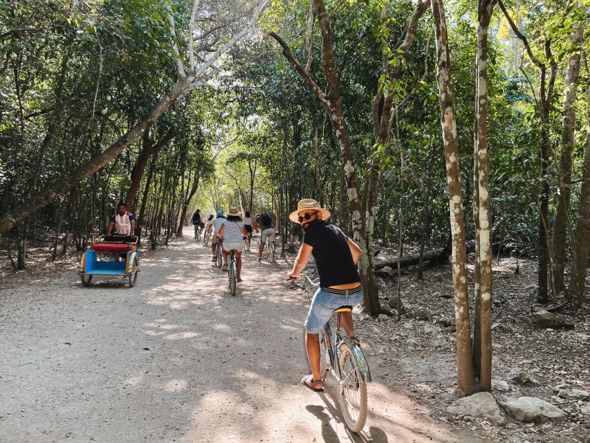 Tourists exploring Cobá on a bike. 