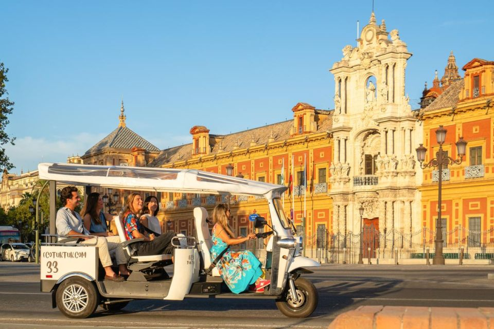 A group of people touring the city of Seville on an electric tuk tuk. 