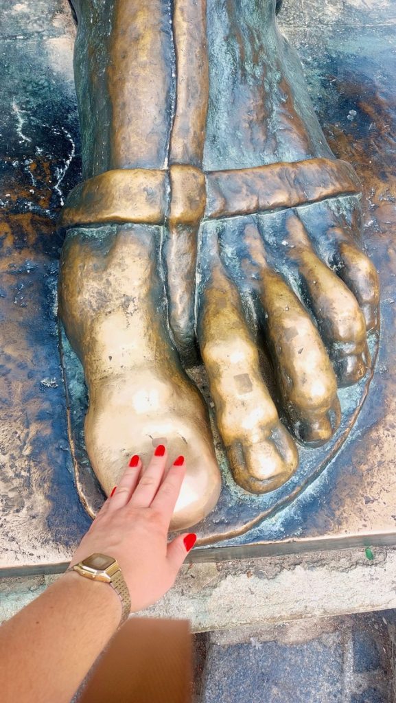 My daughter Lisa touching the big toe of Gregory's foot for good luck.