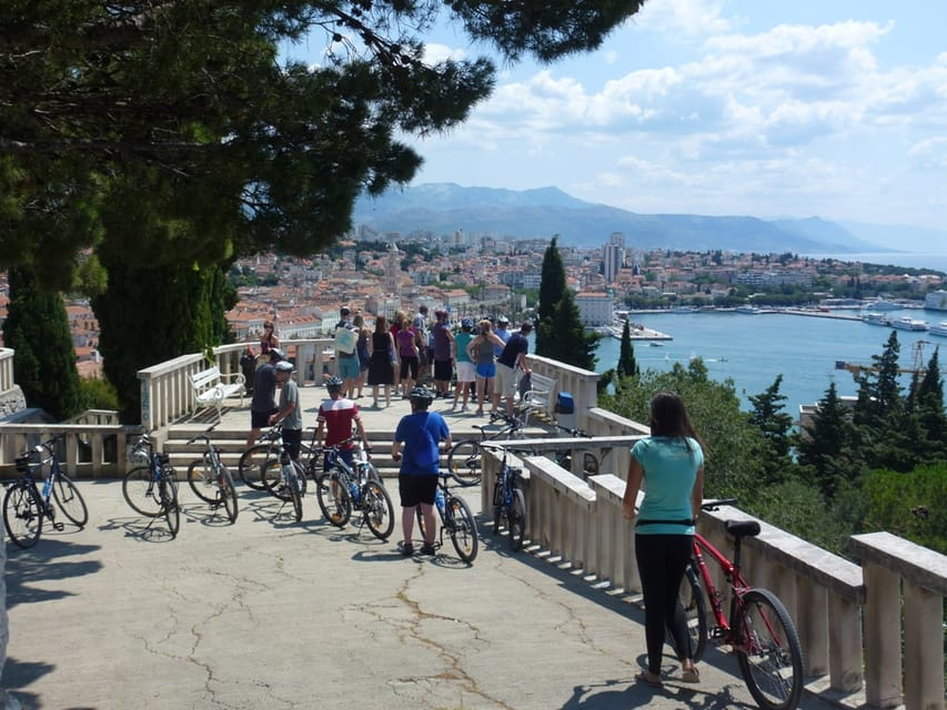 The bike tour includes a visit to the Marjan Hills, high above Split. On this picture you see a group of bikers enjoying a panoramic view of the old city of Split and its surroundings.  