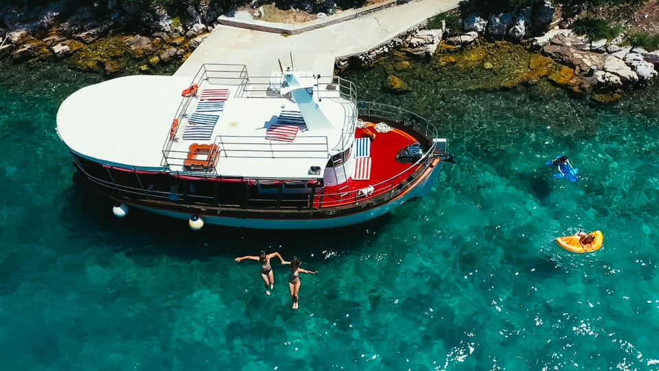 Tourists taking a dive during a boat trip along the islands near Zadar, Croatia. 