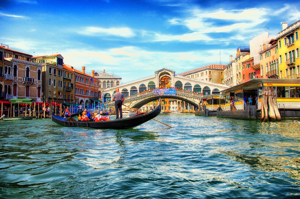 Magical Venice seen from the water. In the background the Rialto Bridge.