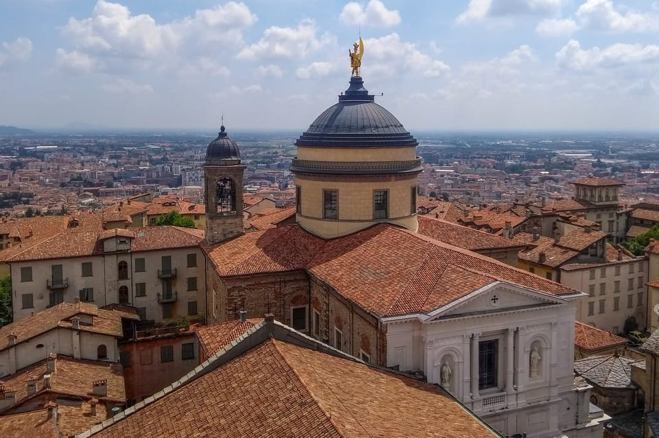 Bird-eye view of the Cathedral of Bergamo. On its impressive dome a statue of the city patron saint Alexander. 