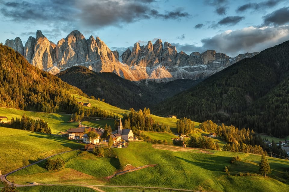 The unique Dolomites in late summer. In the foreground a small community. The background the jagged ridges of the rocky peaks.